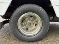 Close-up of a chrome wheel rim with five lug nuts mounted on a tire of a 2007 Ford E-350