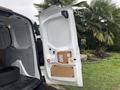 A white 2019 Ford Transit Connect cargo van with the rear door open revealing the interior space and layout