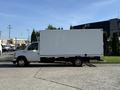 A white 2021 Ford Econoline van with a large box cargo area parked on a concrete surface