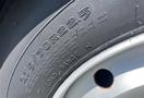 A close-up of a tire with the specifications 275/70R22.5 and details about load range and pressure ratings