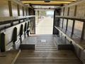 Interior view of a 2012 Ford Econoline cargo van showing metal shelving on both sides and an empty floor space
