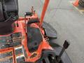 A 2015 Kubota F3990 lawn mower with an orange and black body featuring a seat and controls visible from the operator's perspective