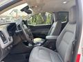 Interior view of a 2017 Chevrolet Colorado featuring a driver's seat and passenger seat in gray fabric with a center console and dashboard visible