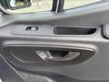 Close-up of the interior door handle and control panel of a 2020 Mercedes-Benz Sprinter 2500 showing window controls and storage space