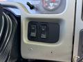 Close-up of a control panel featuring two black buttons labeled Park Regen and Fan Overdrive on a gray textured surface