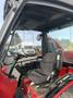 Interior view of a 2013 Toro Grounds Master 5910 featuring a black seat and control panel with levers and buttons