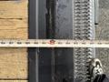 A 2015 GMC Savana van with a measuring tape laid across a wooden surface showing a measurement of 192 inches