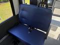 A blue bench seat with a seatbelt in a 2020 Chevrolet Express van