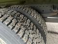 Close-up of a tire belonging to a 2019 Hino 155 showcasing its rugged tread design with visible debris embedded in the grooves