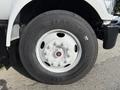 Close-up of a white wheel and tire from a 2018 Ford F-750 showcasing the rim and tread details of the tire