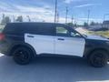 A 2020 Ford Explorer with a black and white paint job parked on a street