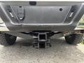 A 2017 Ford F-150's rear bumper showing the hitch receiver and towing connectors