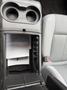 Interior of a 2014 Ford F-150 showing a center console with cup holders and storage compartment