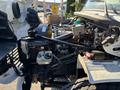 A 2006 Freightliner M2 106 engine compartment showcasing various components including the engine block battery and wiring harness