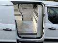 A 2019 Ford Transit Connect with an open rear door showcasing a spacious interior with a checkered metal floor and storage strips on the walls