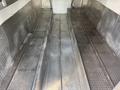 Interior of a 2017 Freightliner MT45 with metal flooring divided into three sloped sections for cargo storage