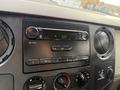 Dashboard of a 2008 Ford F-450 featuring a radio with buttons for AM FM and a digital clock display showing 527