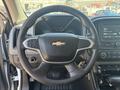 Steering wheel of a 2017 Chevrolet Colorado with a logo in the center and control buttons on the spokes