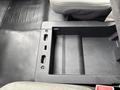 Interior of a 2020 Ford F-150 showing a console space with no items inside and a black rubber floor mat
