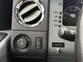 Interior controls of a 2011 Ford F-650 featuring air vents a lights control dial and a dashboard with a speedometer and various switch labels