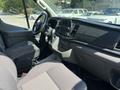 Interior of a 2025 Ford Transit T-350 featuring a steering wheel center console and dashboard with controls and displays