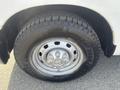 A close-up view of a silver wheel and tire of a 2012 RAM 2500 showcasing the tread pattern and the Goodyear Wrangler branding on the tire