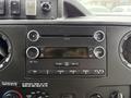 Dashboard of a 2017 Ford E450 featuring a stereo system with buttons for CD, AUX, volume control, and air conditioning settings