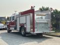 A red 1999 Freightliner FL80 fire truck with silver accents features equipment compartments and lights on top positioned at an angle