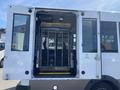A 2020 Chevrolet Express with open doors revealing an interior lift designed to assist passengers with mobility needs
