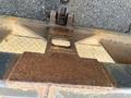 A close-up view of a rusty metal plate attached to a JLG Industries 1014 lift platform showing wear and age
