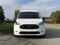 Front view of a white 2020 Ford Transit Connect with a sleek design and prominent grille showcasing the Ford logo