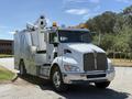 A 2009 Kenworth T270 truck with a white body and silver accents features a bucket lift on the back and multiple safety lights on the cab
