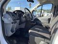 Interior of a 2017 Ford Transit showing the driver's seat steering wheel and dashboard with controls and a gear shift