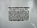 A 2017 Ford F-750 truck featuring a vehicle noise emission control information label from Ford Motor Company