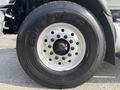 A close-up of a Goodyear tire mounted on a 2013 International WorkStar with a focus on the wheel rim and lug nuts