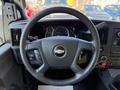 Steering wheel of a 2020 Chevrolet Express with a Chevrolet logo and dashboard gauges visible behind it