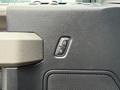A close-up of the door lock and unlock buttons on a 2019 Ford F-150 interior with a textured surface