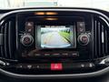 A dashboard screen displaying a rearview camera with guide lines showing the surroundings of a vehicle