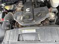 Close-up of a 6.7L turbo diesel engine in a 2011 Dodge Ram 5500 featuring various components and labels on the engine cover