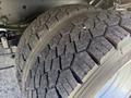 Close-up of a rugged tire from a 2020 Ford F-550 showcasing an aggressive tread pattern designed for durability and traction