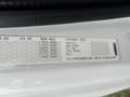A label from a 2013 Freightliner 114SD displaying specifications and component information including chassis engine transmission and rear axle details
