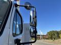 A 2006 Freightliner M2 106 truck with a prominent side mirror and exterior details visible