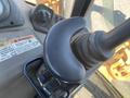 Close-up of the joystick and control panel in a 2016 Case 580 Super N construction vehicle