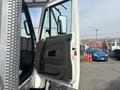 A 2012 International 7300 Workstar truck with the driver's side door open showcasing the interior door panel and handle