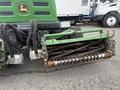 2009 John Deere 2653B Precision Diesel Mower with a green body and a cutting front reel featuring a series of sharp blades and metal components