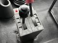Control panel with two levers for operating functions like lower, raise, out and in on a 2006 International 4200