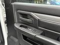 The interior door panel of a 2024 RAM 5500 featuring a textured black surface with a door handle and a power window control panel