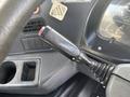 The image shows the control lever of a 2012 Autocar Xpert featuring a switch for activating headlights with a textured grip and an indicator for the off position