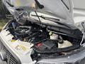 A 2021 Ford Transit-350 engine bay showing the engine and various components including hoses and fluids