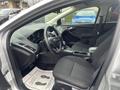 Interior of a 2018 Ford Focus featuring cloth seats a central console and a compact dashboard with controls and display elements